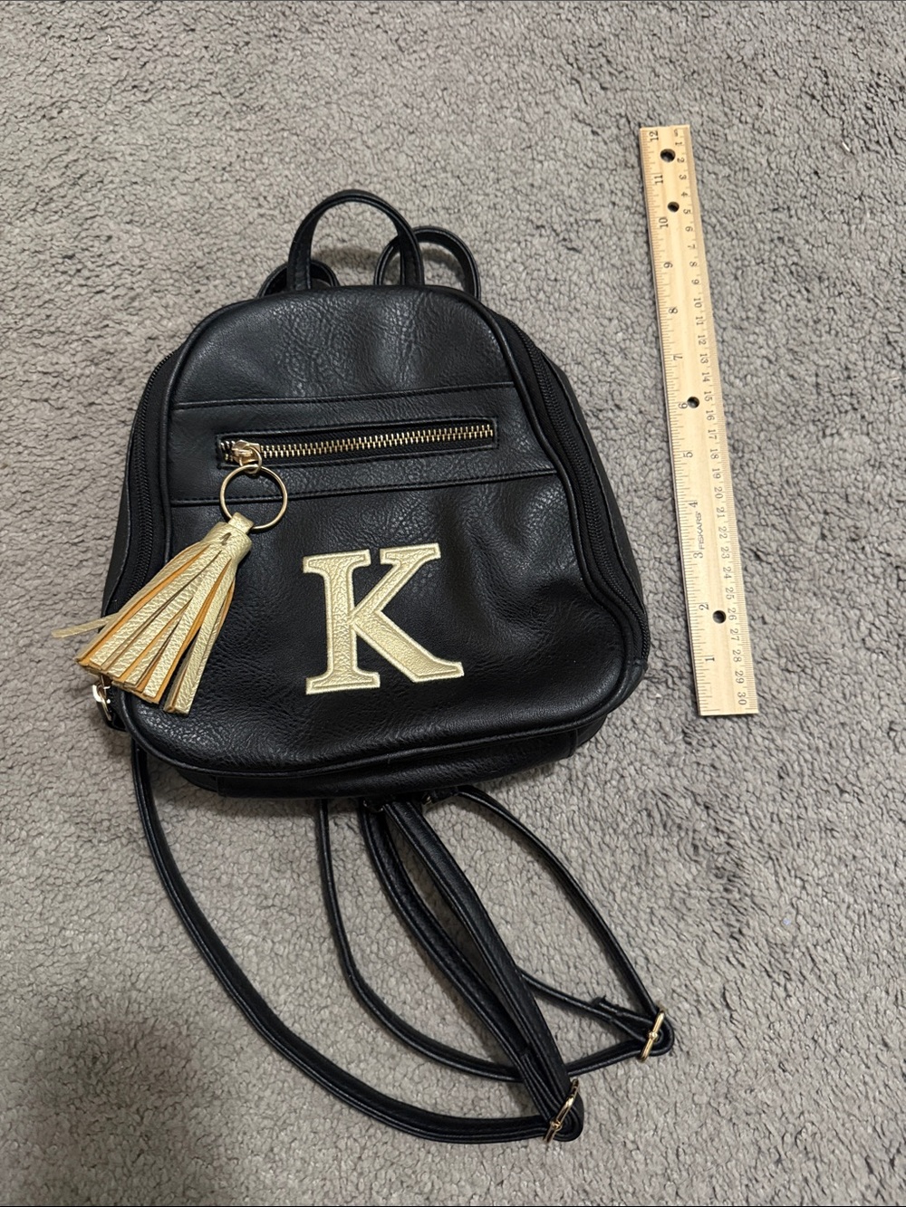 Cute small black backpack with letter “K” on it in gold color